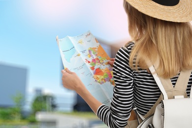 Happy traveler with map in foreign city. Summer vacation trip