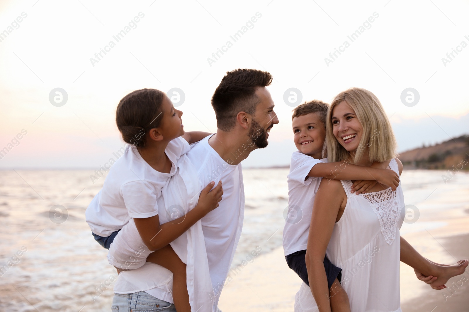 Photo of Happy family on beach near sea. Summer vacation