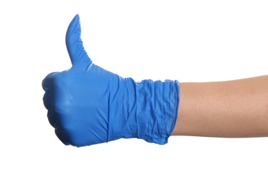 Photo of Woman in blue latex gloves showing thumb up gesture on white background, closeup of hand