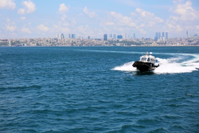 Photo of Beautiful view of ship in sea with city on background