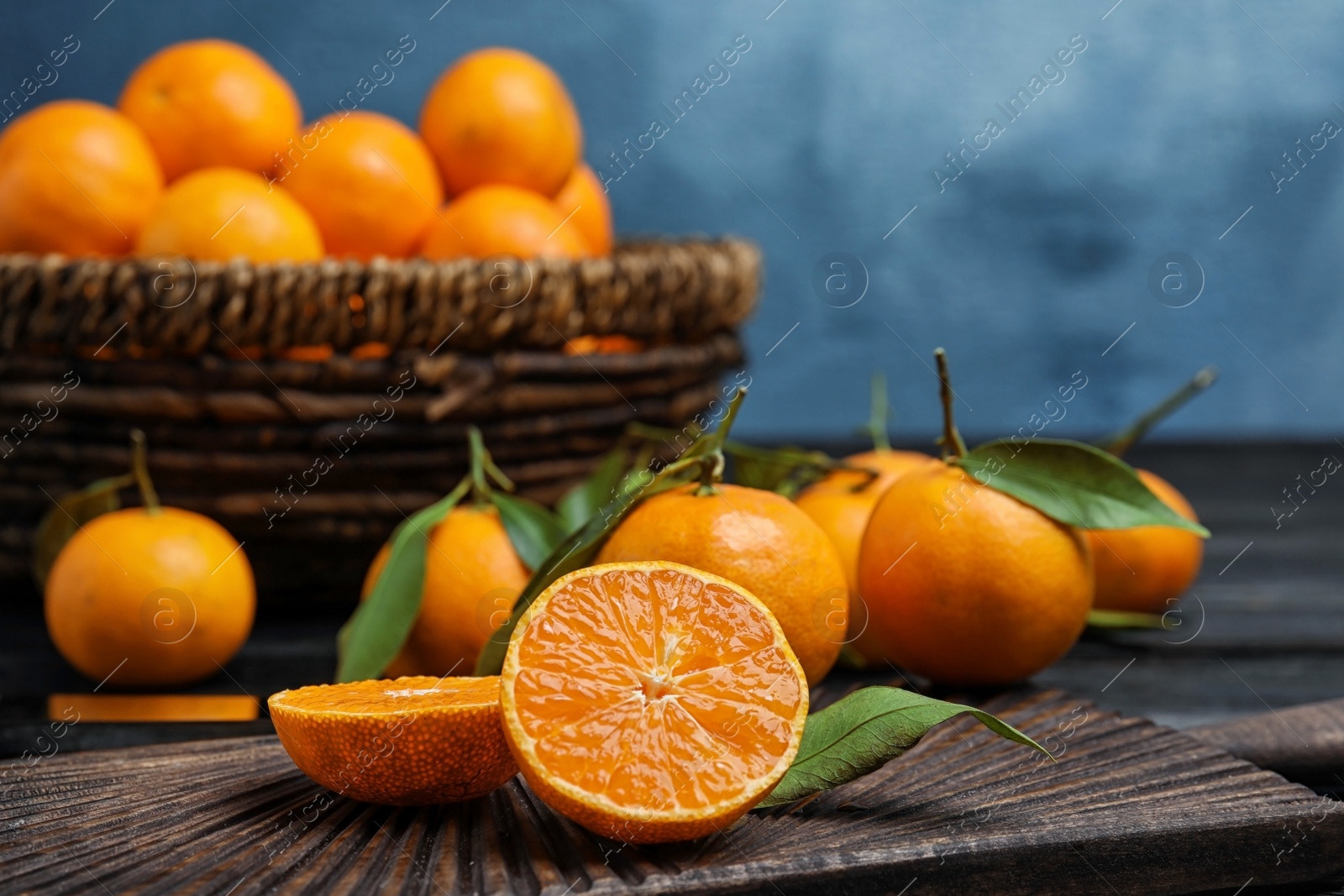 Photo of Fresh juicy cut tangerine on wooden board