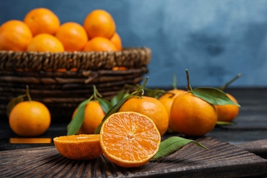 Photo of Fresh juicy cut tangerine on wooden board