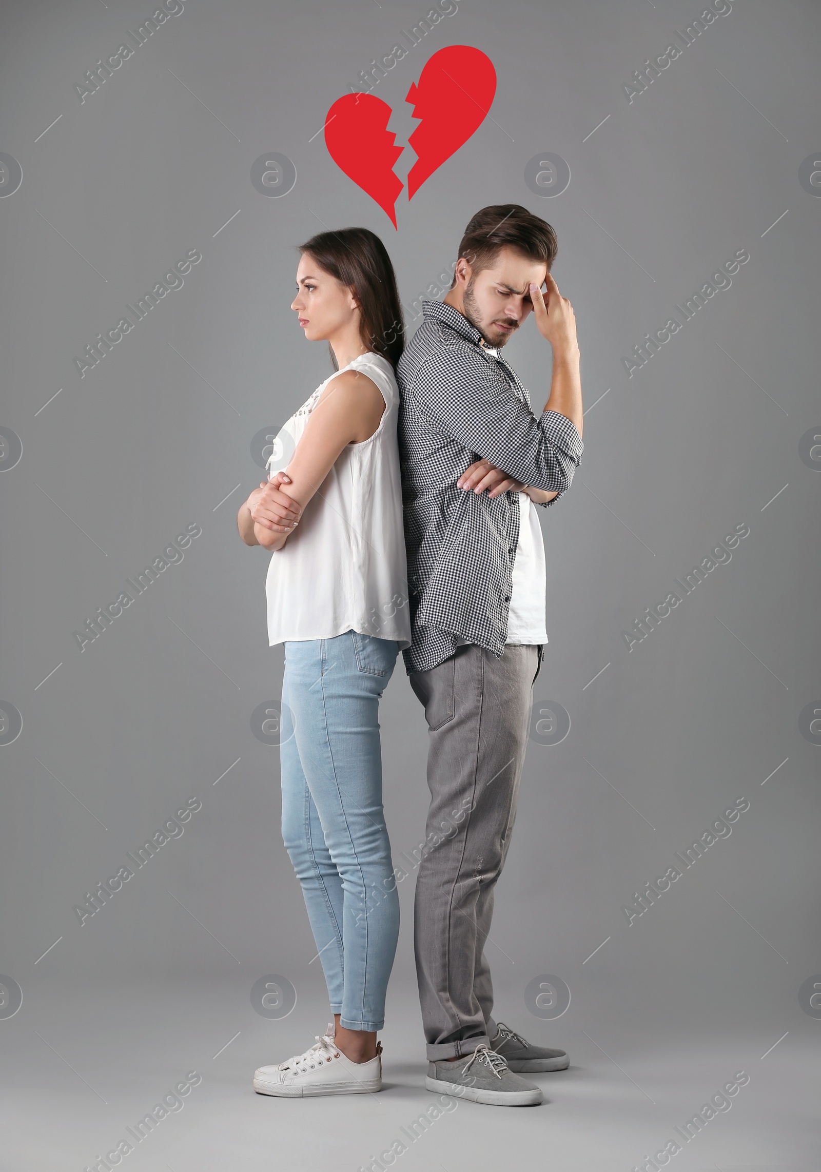 Image of Upset young couple and illustration of broken heart on grey background. Relationship problems