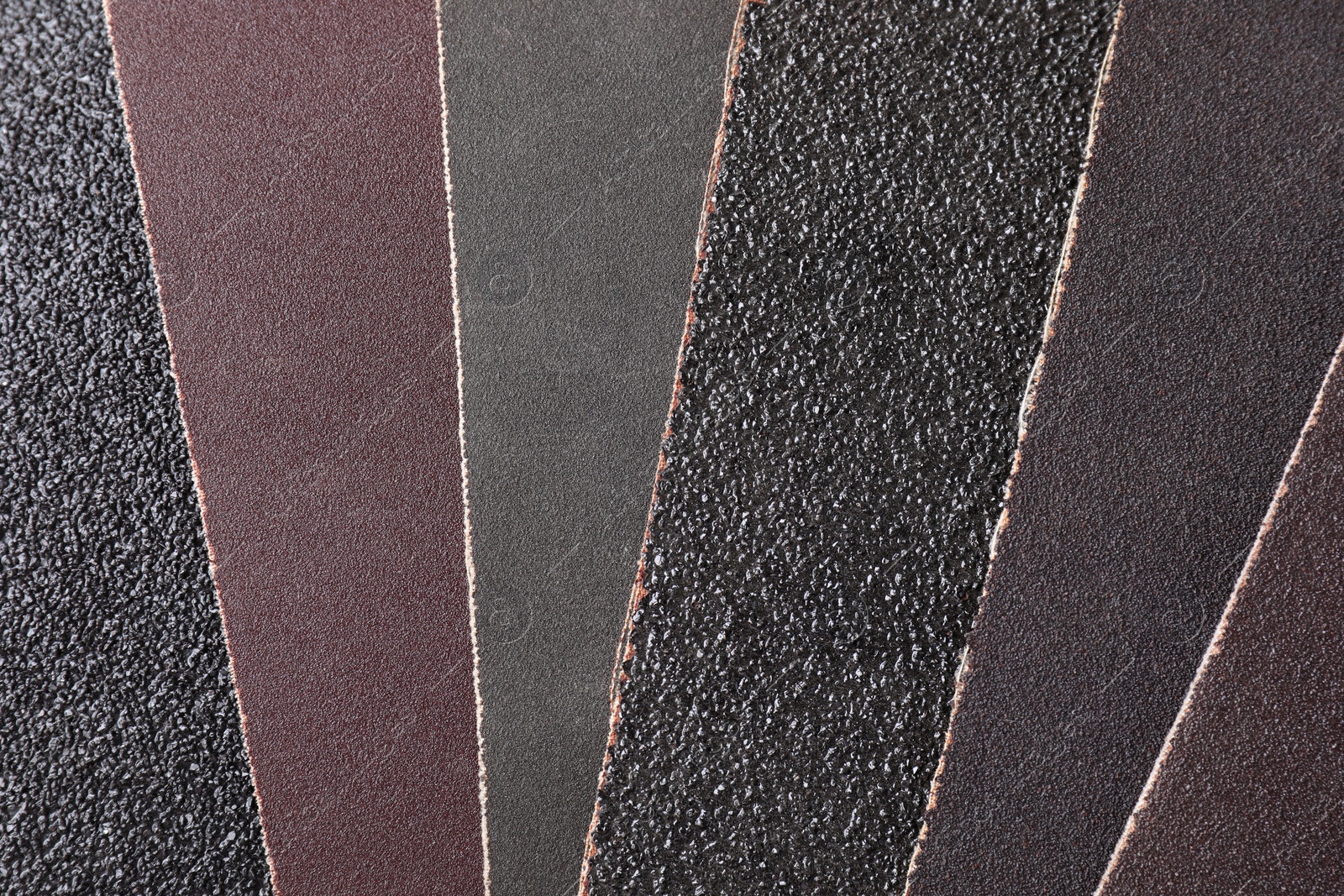 Photo of Many sheets of sandpaper as background, top view