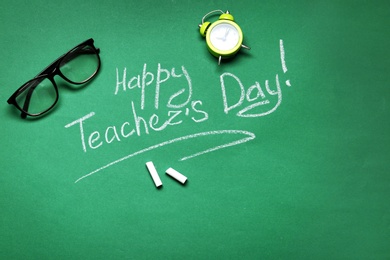 Photo of Flat lay composition with words HAPPY TEACHER'S DAY on chalkboard