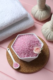 Photo of Composition with sea salt and herbal bags on pink wooden table, above view
