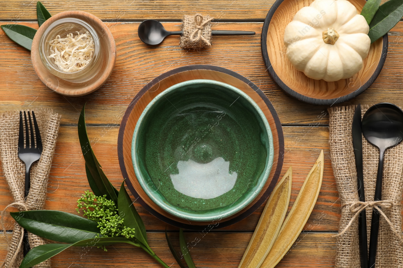 Photo of Autumn table setting with pumpkin and decor on wooden background, flat lay