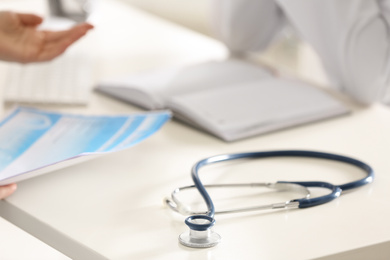 Photo of Stethoscope on desk in doctor's office, closeup