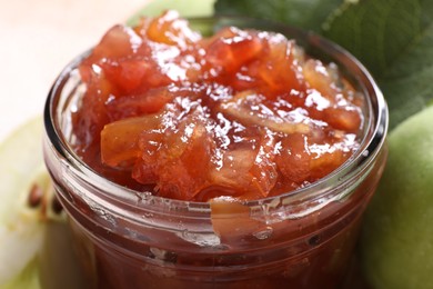 Photo of Glass jar of delicious apple jam, closeup