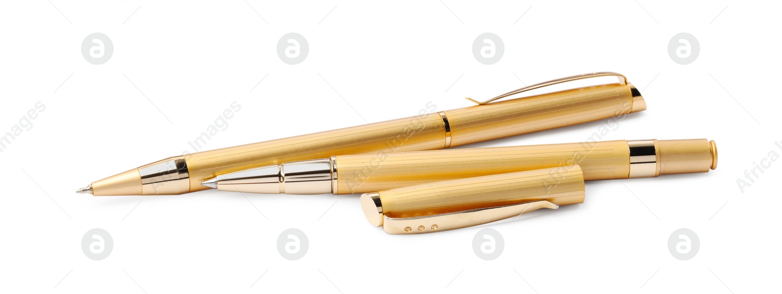 Photo of New stylish golden pens isolated on white