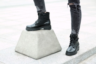 Photo of Woman wearing comfortable stylish boots outdoors, closeup