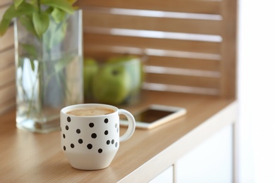 Photo of Cup of aromatic coffee on table