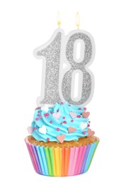 18th birthday. Delicious cupcake with number shaped candles for coming of age party on white background