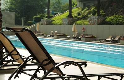 Sunbeds near swimming pool at luxury resort