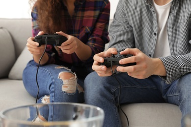 Photo of Young couple playing video games at home, closeup