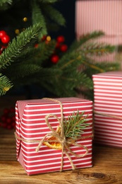 Photo of Beautifully wrapped gift box on wooden table
