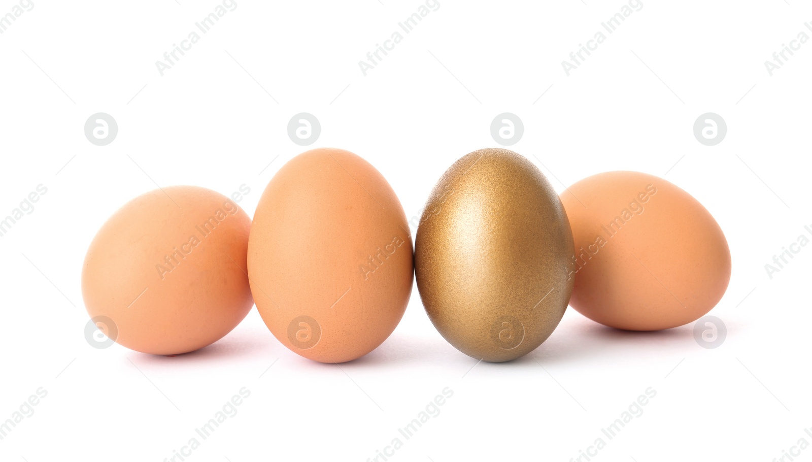 Photo of Golden egg among others on white background