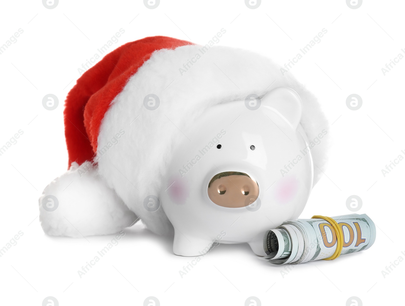 Photo of Piggy bank with Santa hat and dollar banknotes on white background