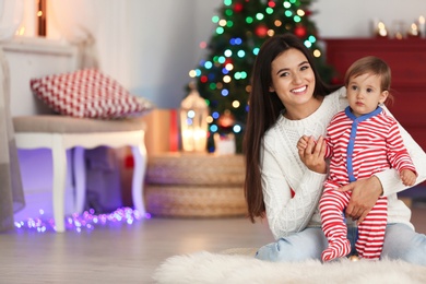 Photo of Mother and her cute baby at home. Christmas celebration