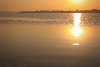 Photo of Picturesque view of beautiful sunrise on riverside. Morning sky