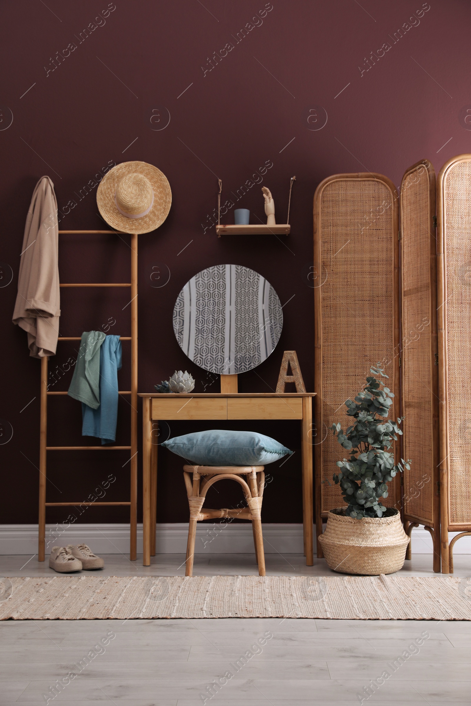 Photo of Stylish furniture, beautiful eucalyptus and decorative elements in room. Interior design