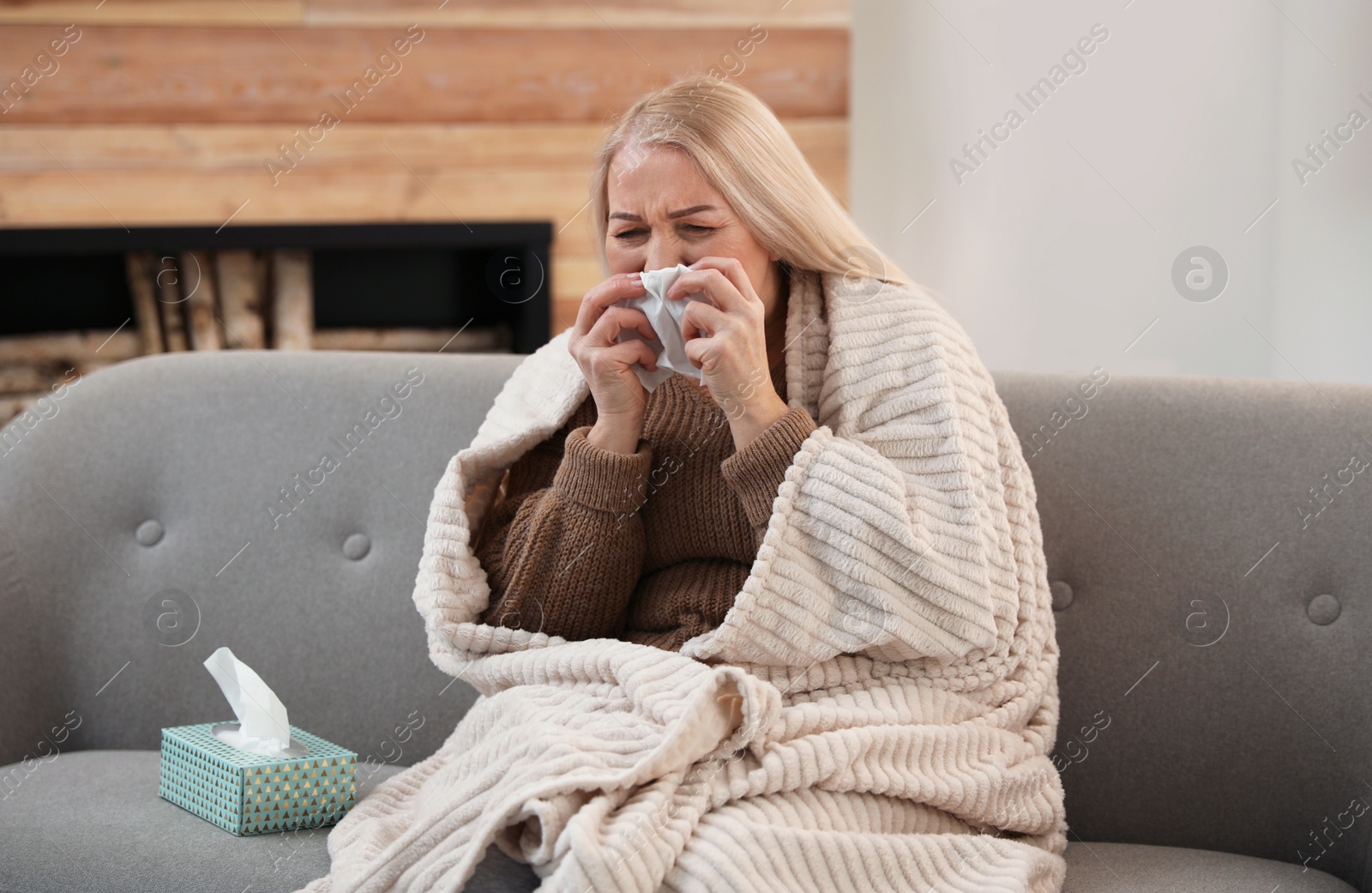 Photo of Mature woman suffering from cold at home. Dangerous virus