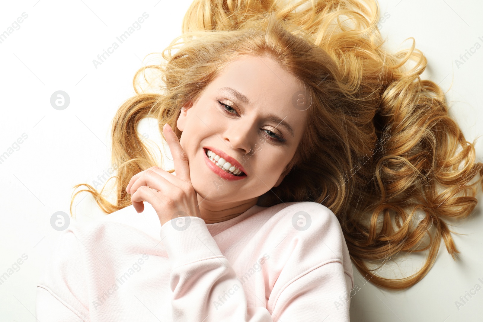 Photo of Portrait of beautiful young woman with dyed long hair on white background, top view