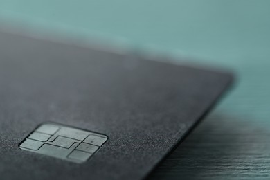 One credit card on color background, macro view