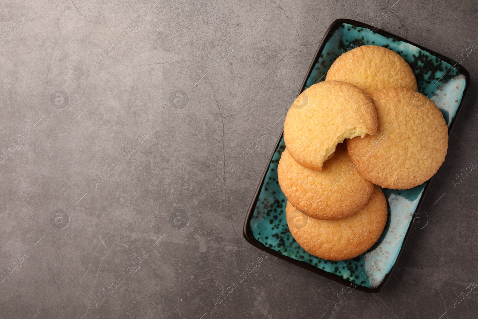 Photo of Delicious Danish butter cookies on grey table, top view. Space for text