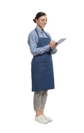 Beautiful young woman in clean denim apron with clipboard on white background