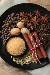 Dishware with different spices on table, top view