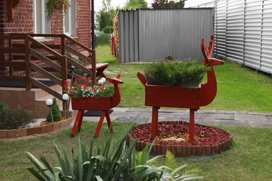 Photo of Deer shaped pots with plants in garden