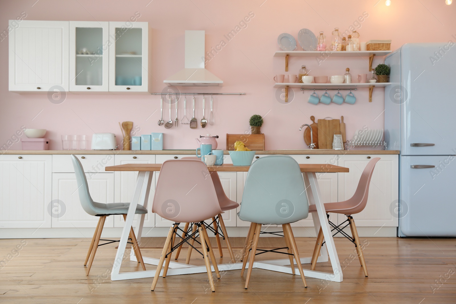 Photo of Stylish kitchen interior with dining table and chairs