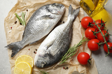 Photo of Flat lay composition with raw dorada fish on table