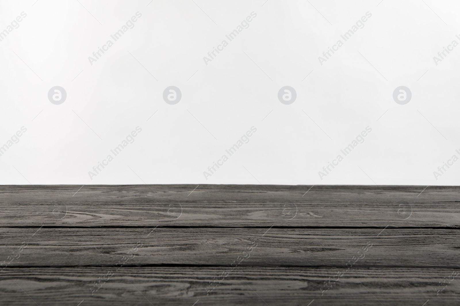 Photo of Empty grey wooden surface on white background. Space for text