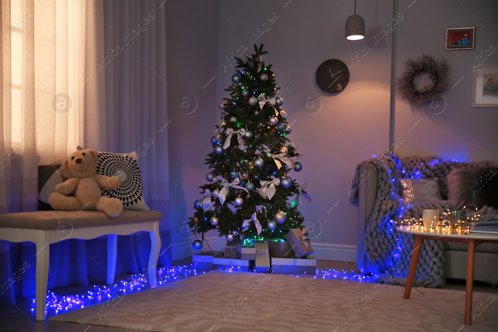 Photo of Room interior with beautiful Christmas tree and gifts