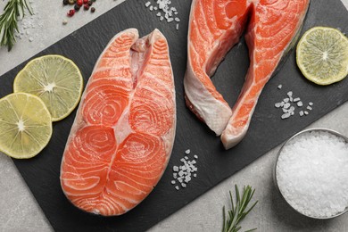 Photo of Fresh salmon and ingredients for marinade on light grey table, flat lay