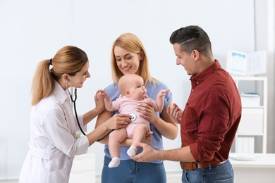 Parents with their baby visiting children's doctor in hospital