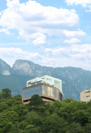 Photo of Beautiful view of buildings and green plants near mountains