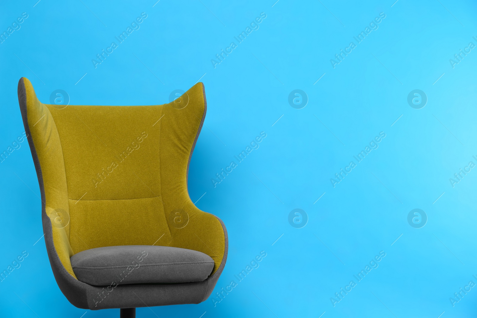 Photo of Comfortable office chair on light blue background, space for text