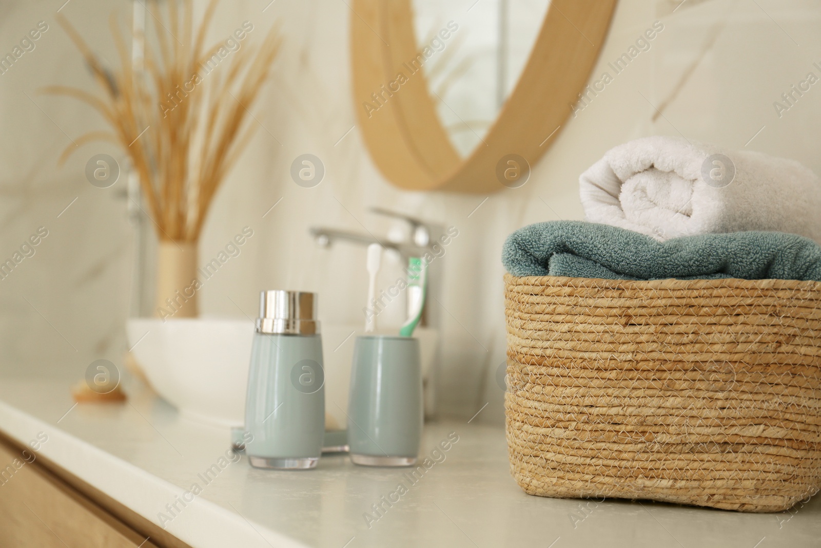 Photo of Fresh towels and toiletries on white countertop in bathroom