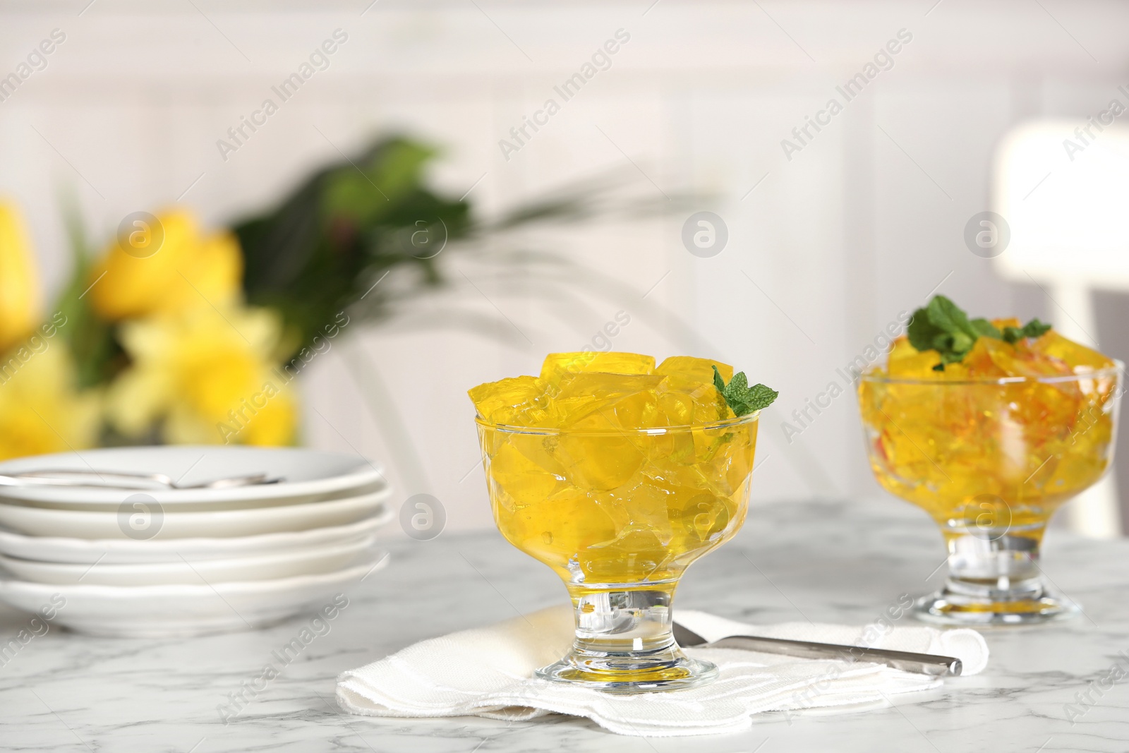 Photo of Dessert bowls of jelly served on table. Space for text