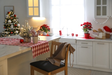 Beautiful kitchen interior with Christmas tree and festive decor