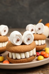 Delicious Halloween themed dessert on wooden table, closeup