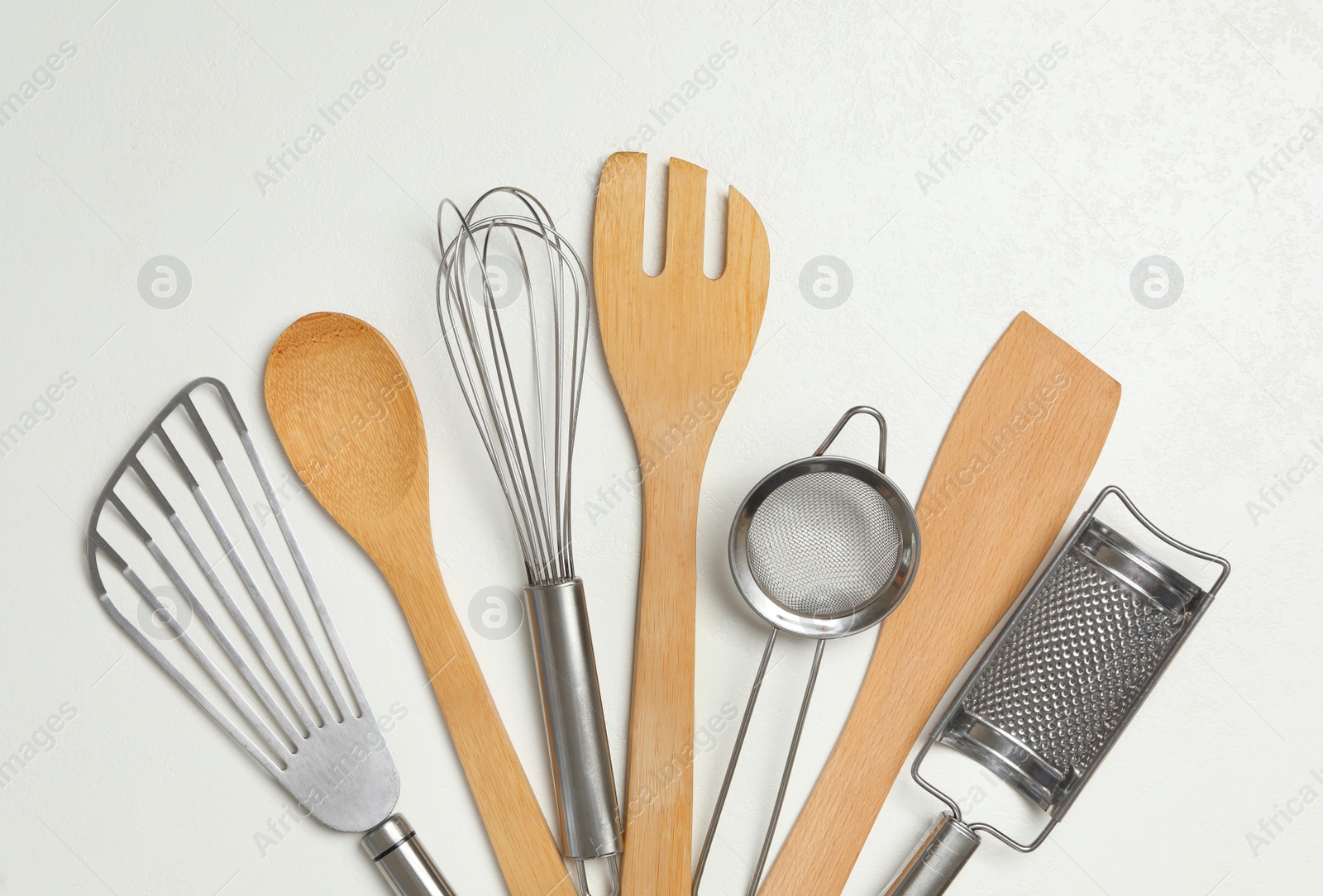 Photo of Set of cooking utensils on white background, flat lay