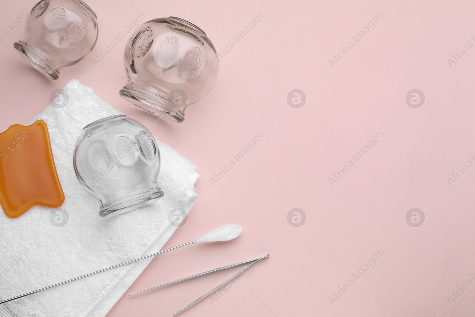 Photo of Flat lay composition with glass cups on pink background, space for text. Cupping therapy