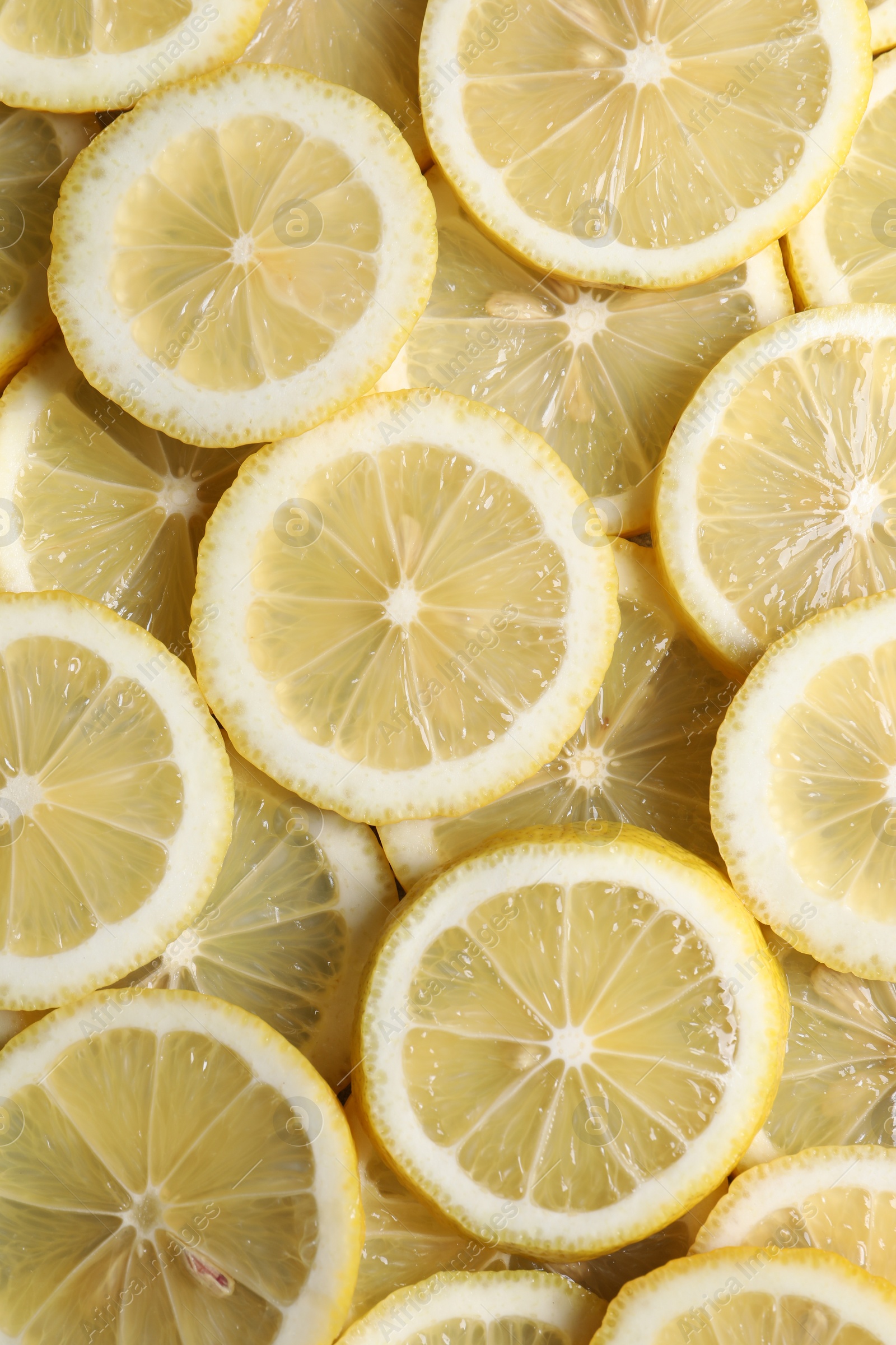 Photo of Slices of fresh lemons as background, top view