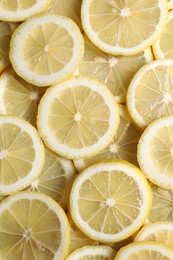 Slices of fresh lemons as background, top view