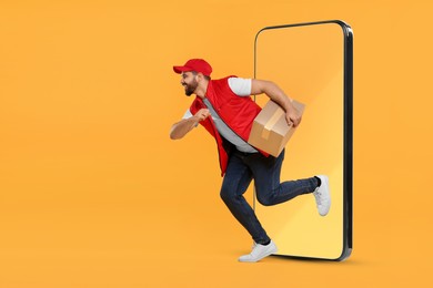 Courier with parcel running out from huge smartphone on orange background. Delivery service. Space for text