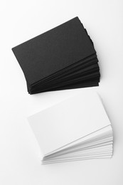 Photo of Blank business cards on white background, flat lay. Mockup for design